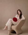 Dalene holding a red rose in an elegant setting